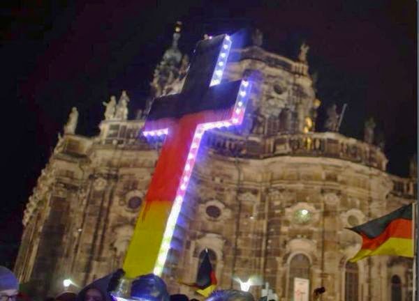 A Cross painted in German colours at a Pegida anti-Muslim demonstration in Dresden